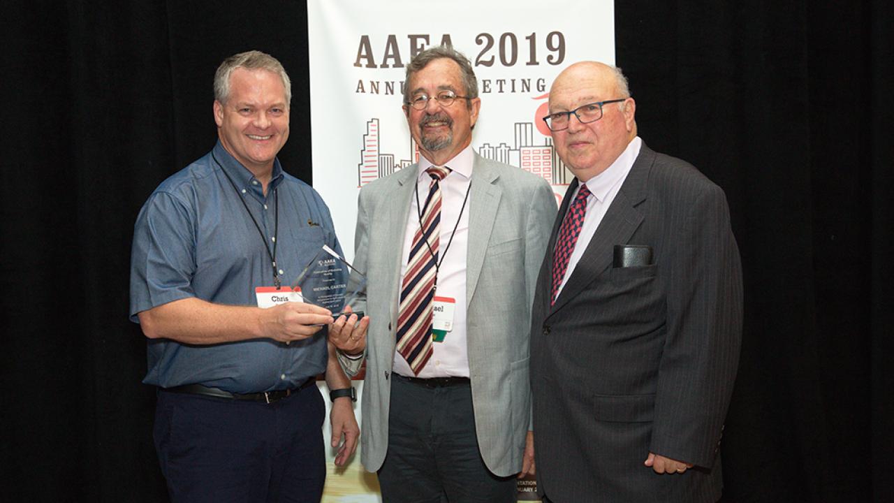 Christopher Barrett (left) and Michael Carter (center) with former AAEA president David Zilberman (right) Barrett and Carter AAEA