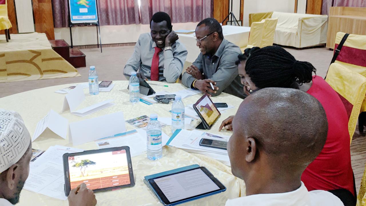 Uganda event participants try SimPastoralist, an index insurance research and education tool developed by Andrew Hobbs at UC Davis Uganda event